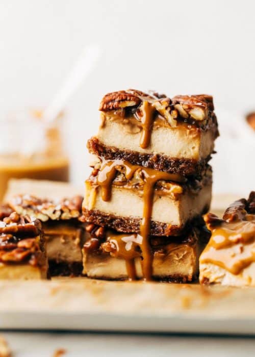 a stack of three slices of caramel pecan cheesecake bars