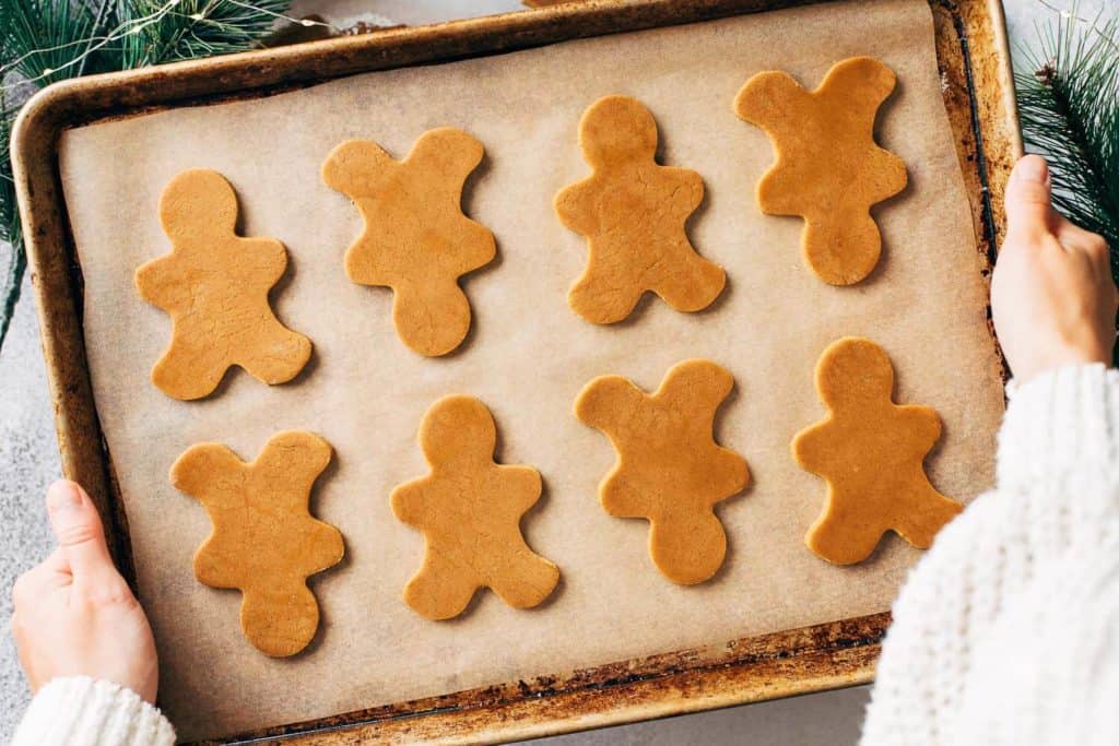 gingerbread men cookie dough on a baking sheet