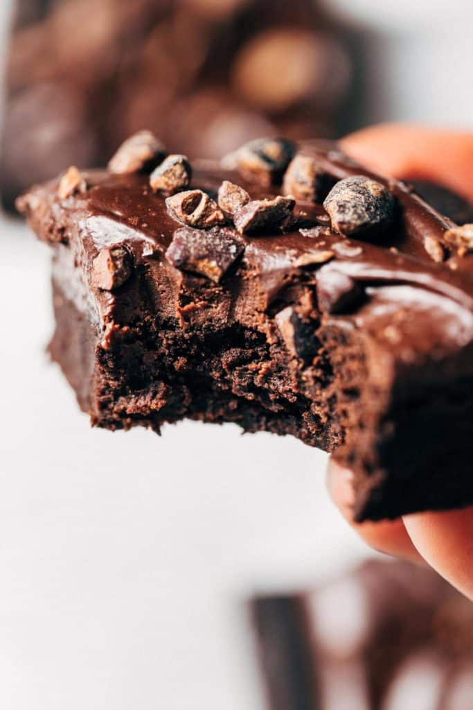 holding a chickpea brownie with a bite taken out