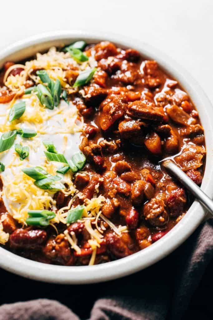a spoon in a bowl of chili
