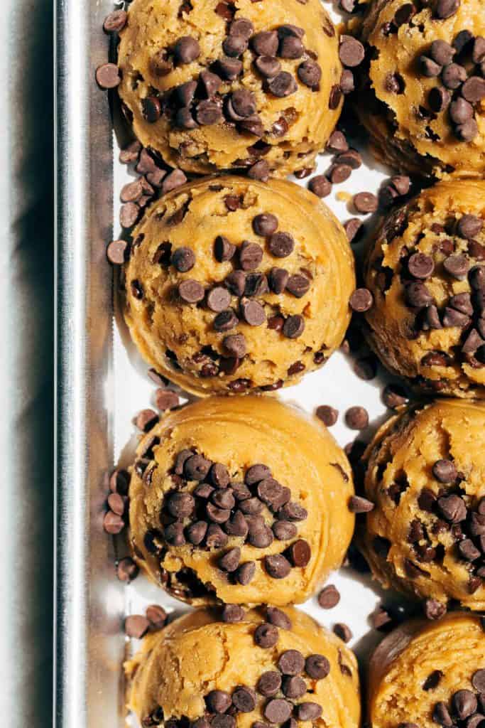 peanut butter chocolate chip cookie dough scooped on to a tray