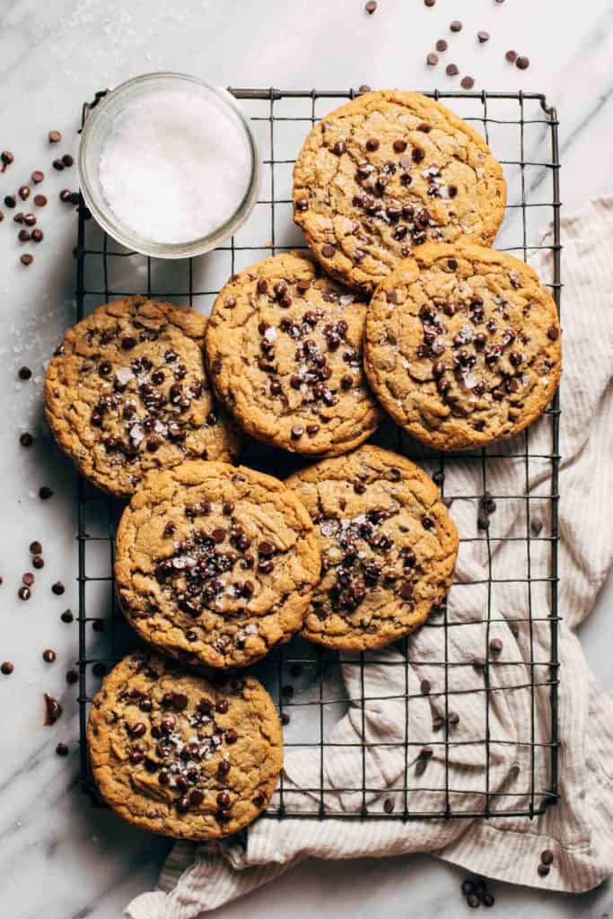 peanut butter chocolate chip cookies scattered on a cooling rack