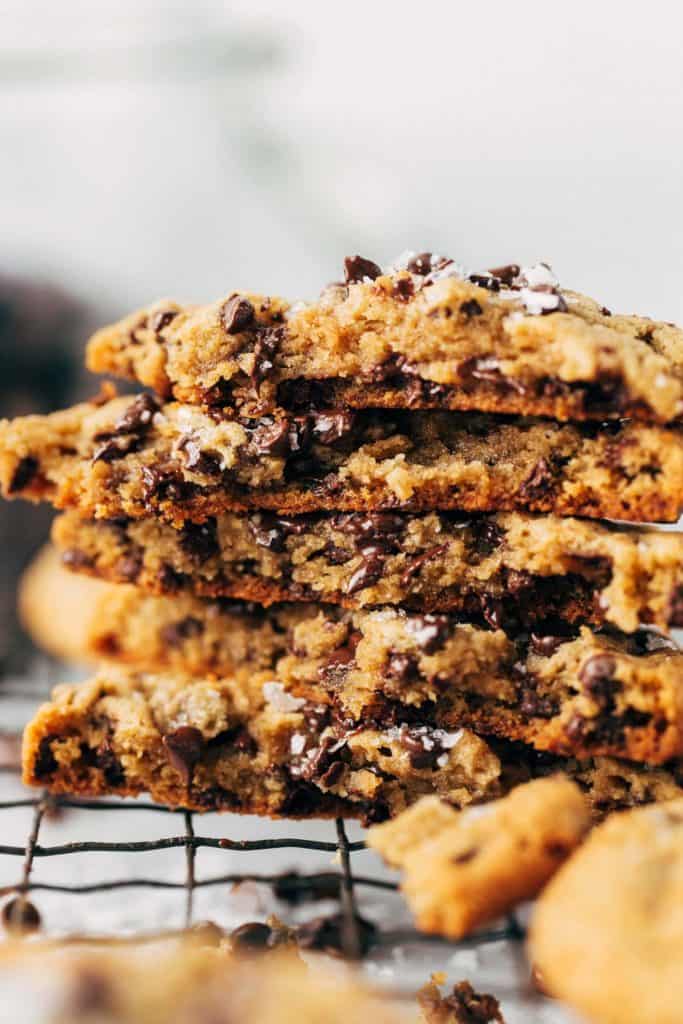 a stack of peanut butter chocolate chip cookies split in half