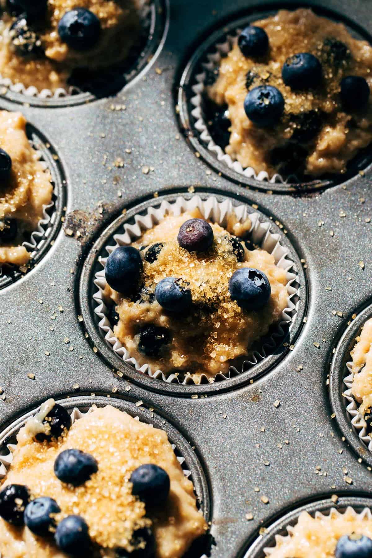blueberry muffin batter scooped in a muffin tin