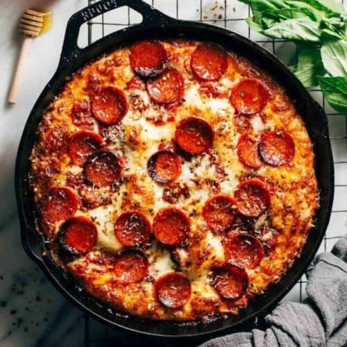 the top view of detroit style pizza in a cast iron skillet