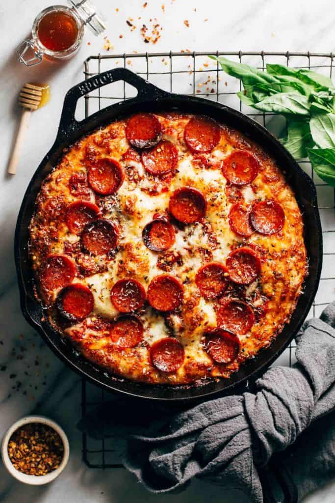 the top view of detroit style pizza in a cast iron skillet