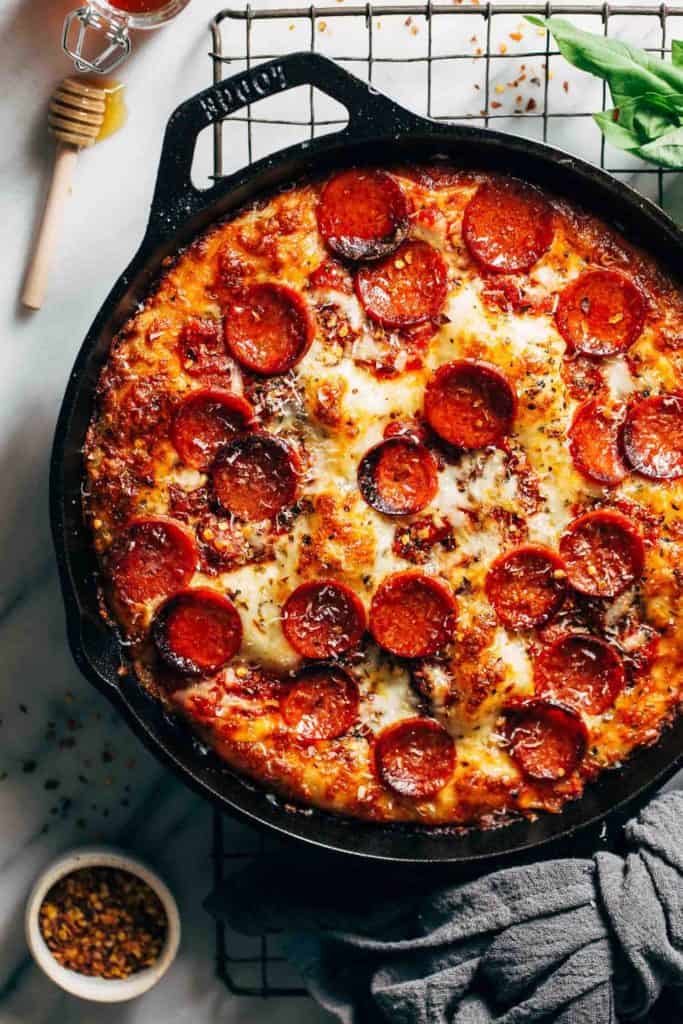 the top of a detroit style pizza baked in a skillet