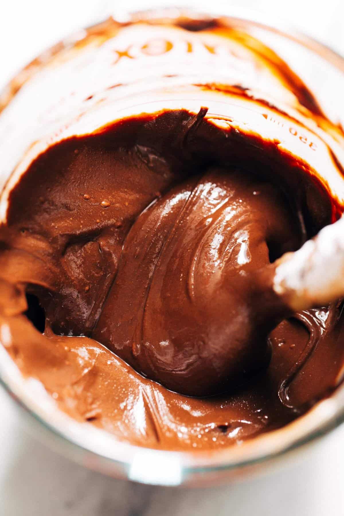 a bowl of melted chocolate frosting