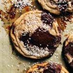 close up on a miso chocolate chip cookie sprinkled with sesame seeds