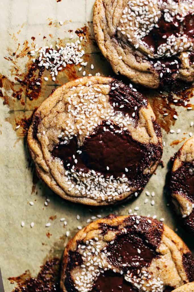 close up on a miso chocolate chip cookie sprinkled with sesame seeds