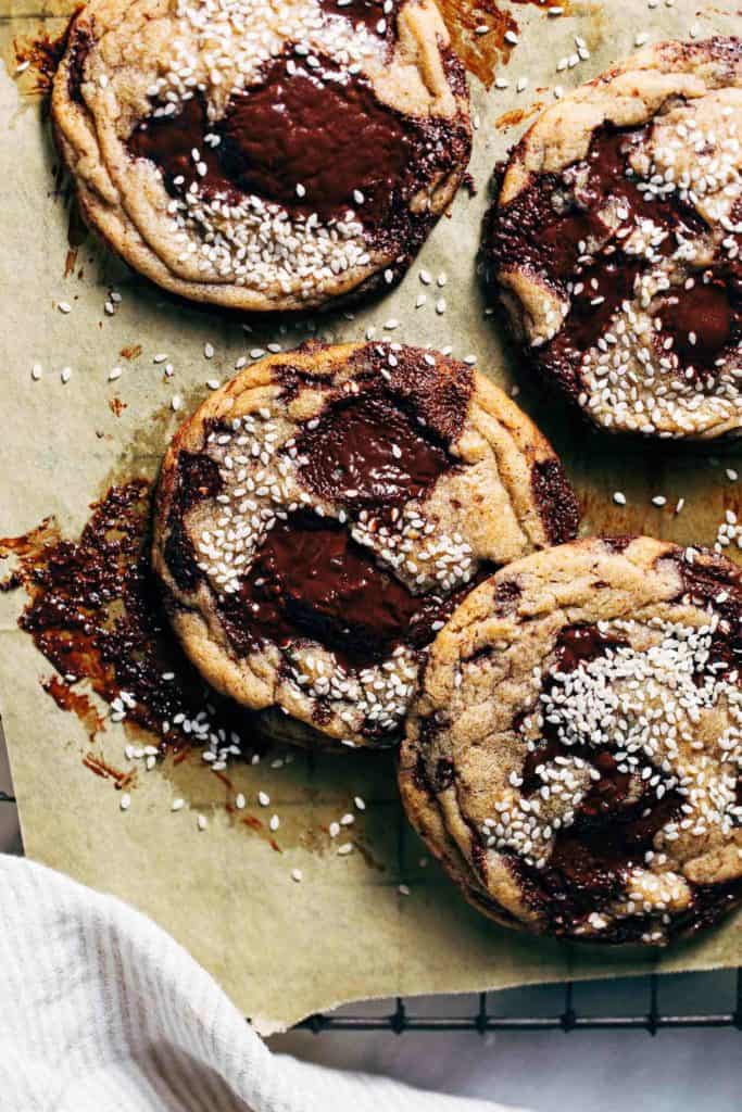 miso chocolate chip cookies scattered on parchment paper