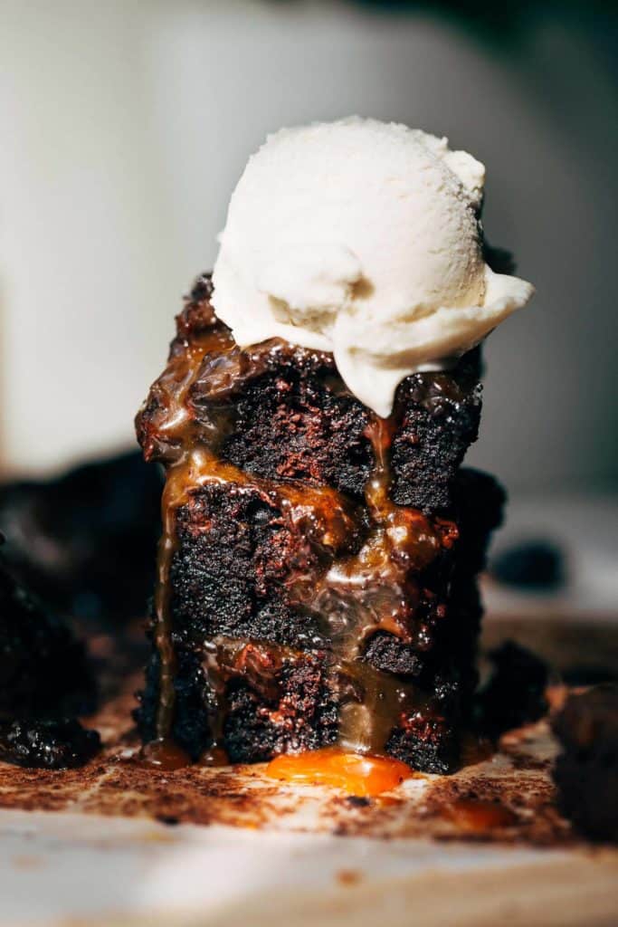 a stack of salted caramel brownies with ice cream on top