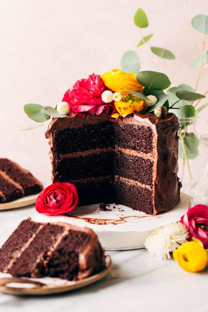 a sliced gluten free chocolate cake on a cake stand