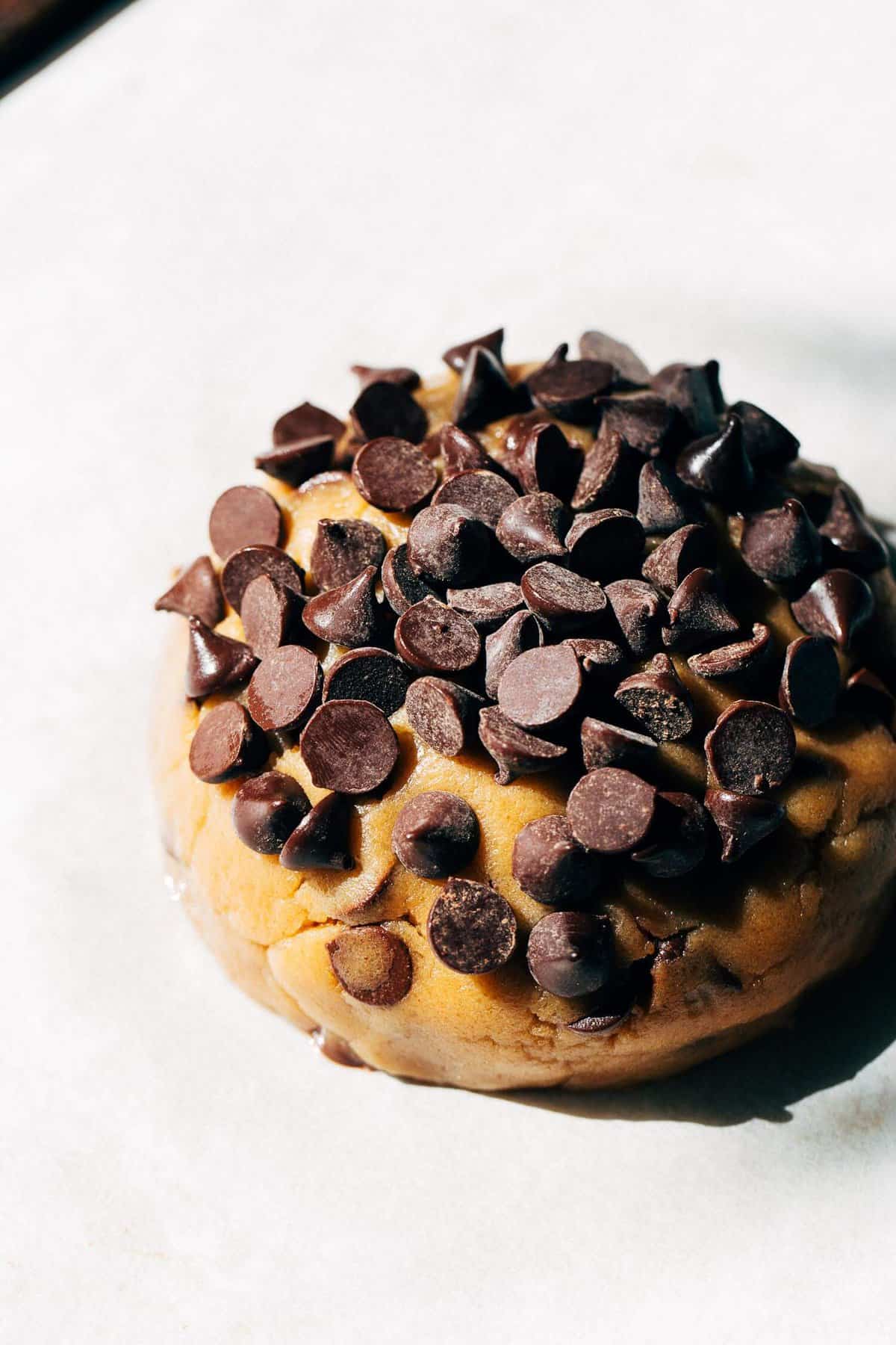 a giant ball of cookie dough covered in chocolate chips