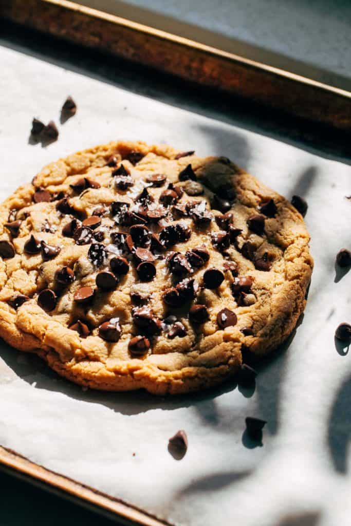 a giant chocolate chip cookie on a baking pan