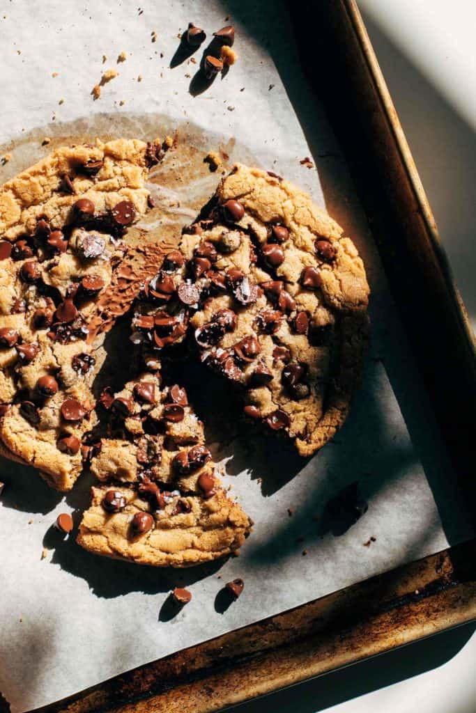 a giant chocolate chip cookie on a baking pan