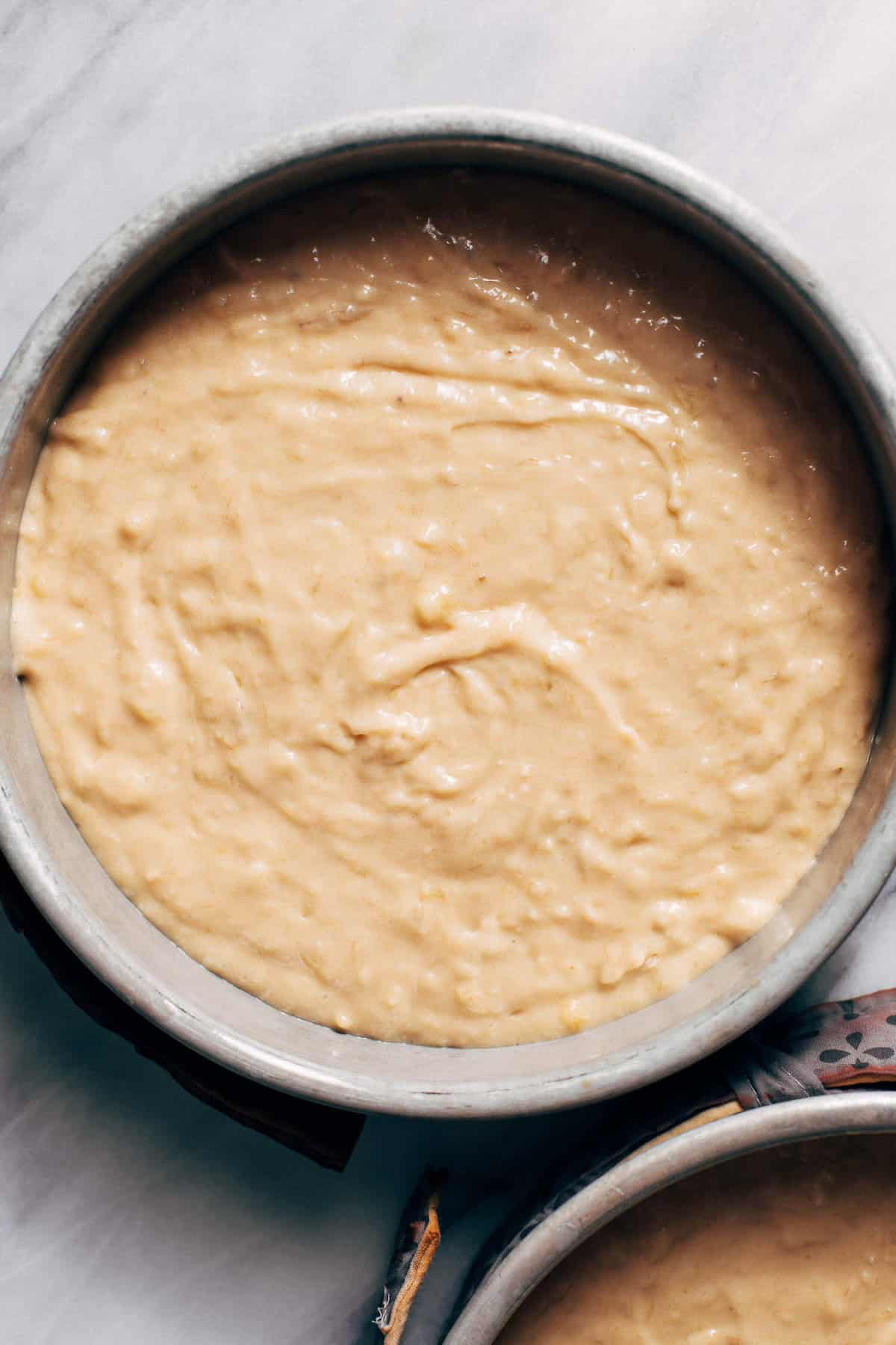 banana cake batter in cake pans