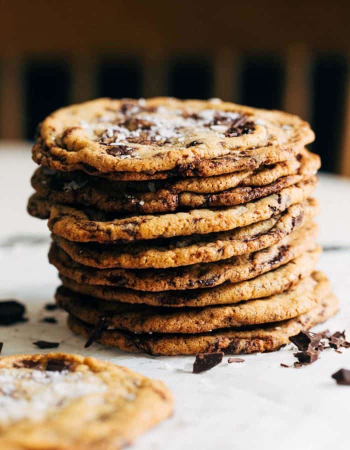 a stack of thin and crispy chocolate chip cookies