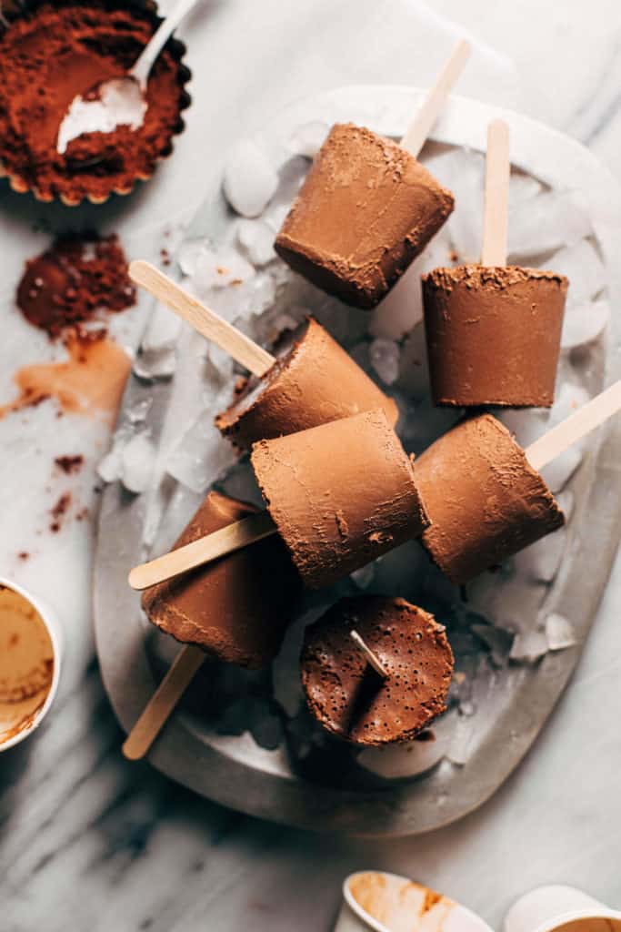 chocolate pudding pops in a tray of ice