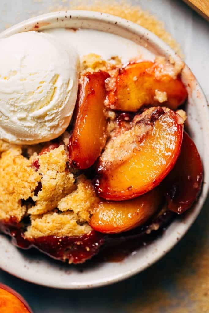 close up on tender slices of baked peach cobbler