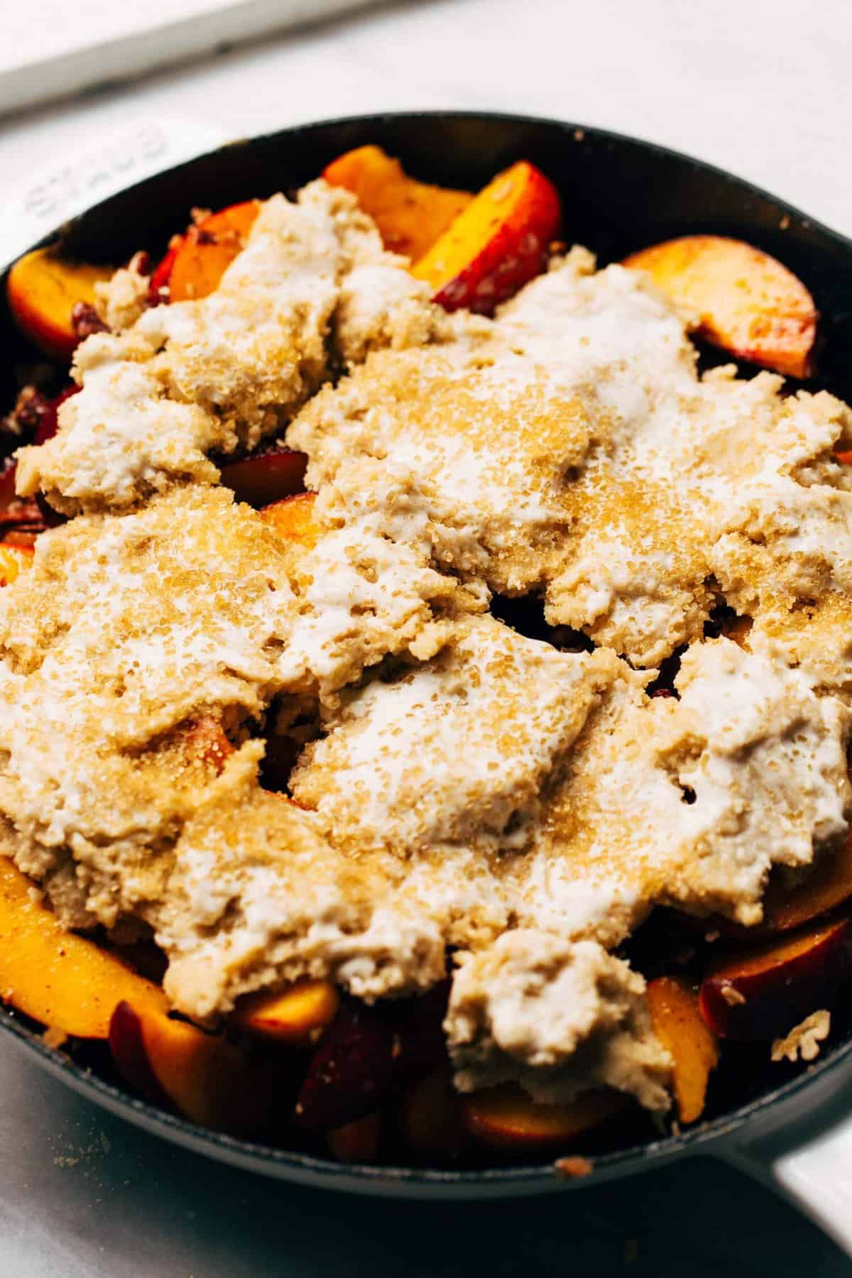 cobbler dough on top of baked peaches