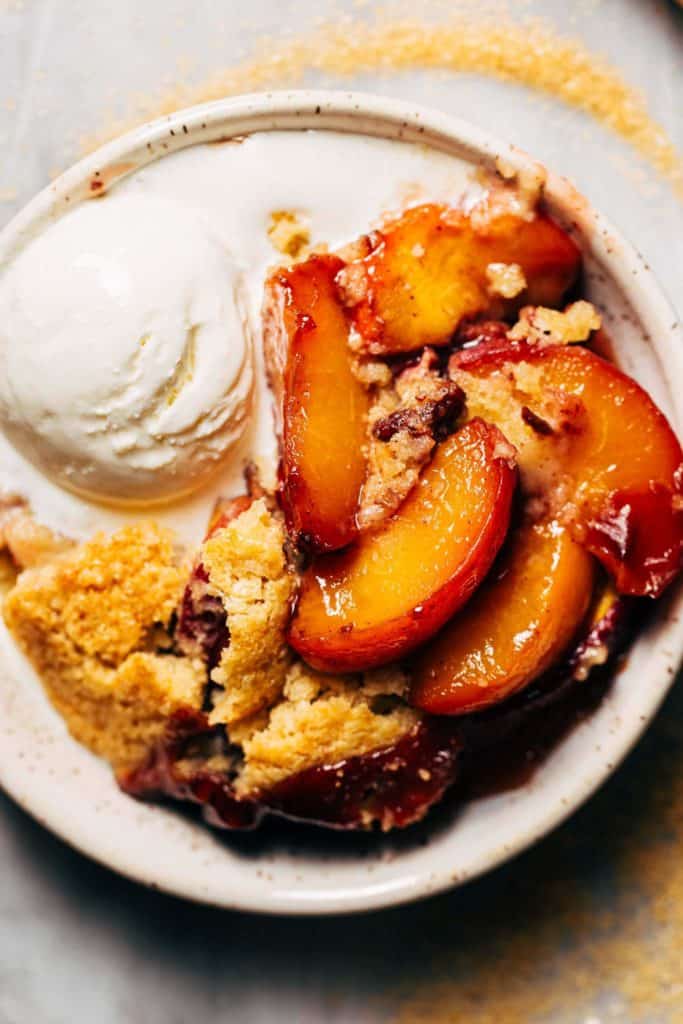 a bowl of fresh peach cobbler