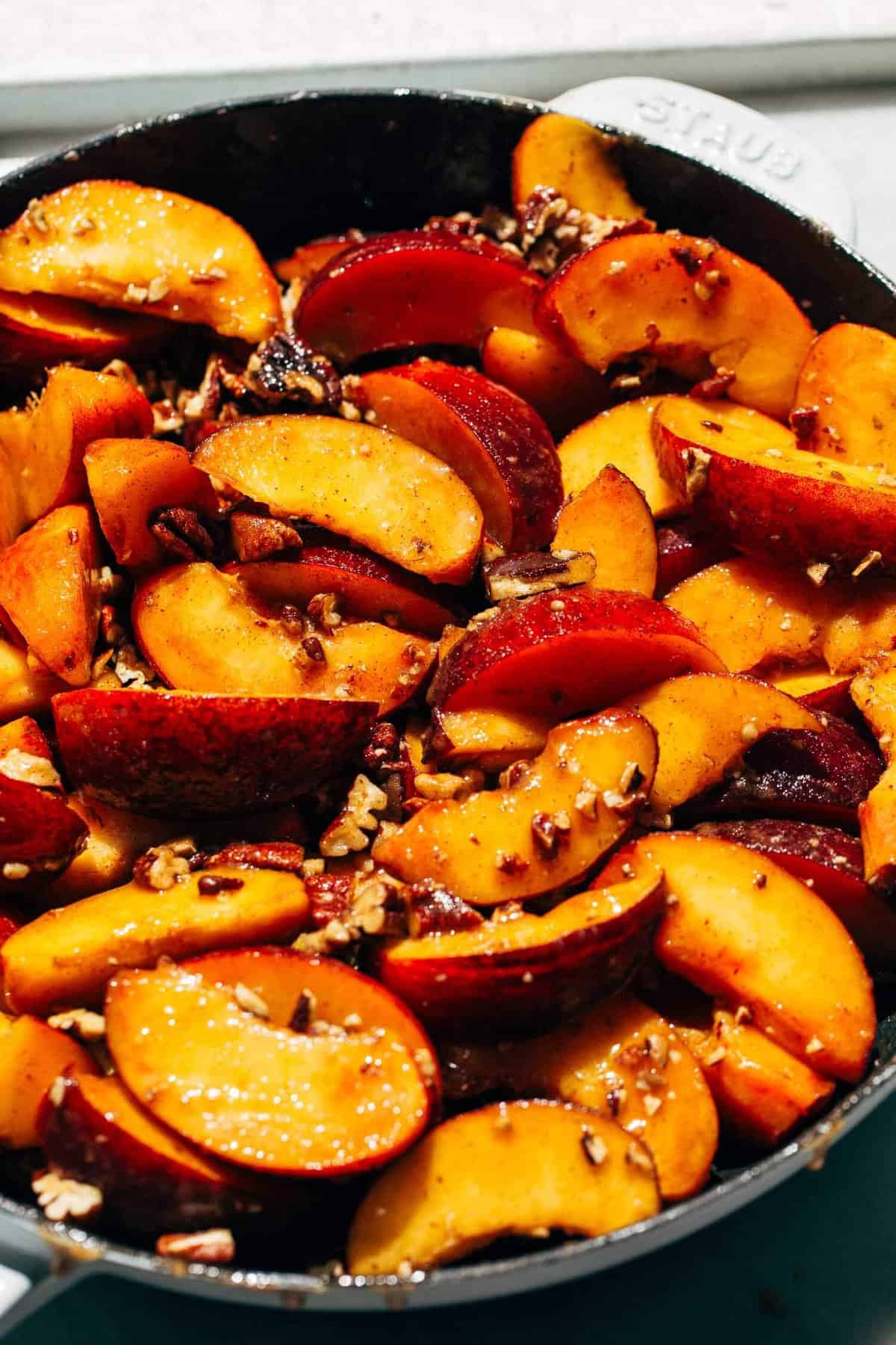 sliced peaches tossed in sugar and toasted peaches and spread in a cast iron skillet
