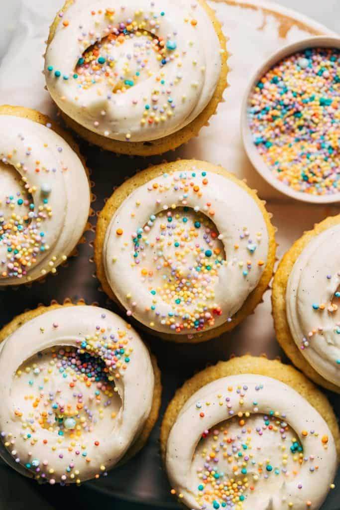 the tops of vanilla cupcakes with swirls of vanilla buttercream