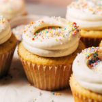 vanilla cupcakes with swirled vanilla buttercream and colorful sprinkles
