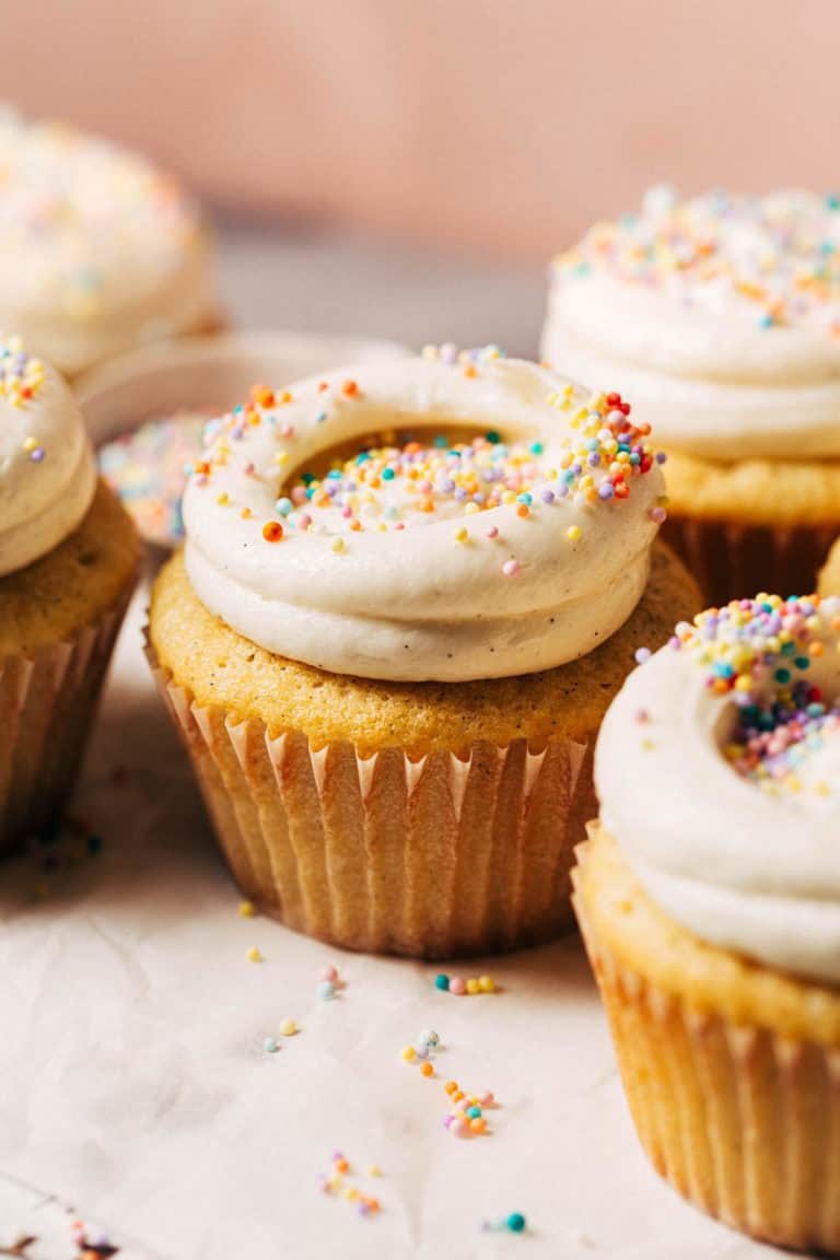 vanilla cupcakes with swirled vanilla buttercream and colorful sprinkles
