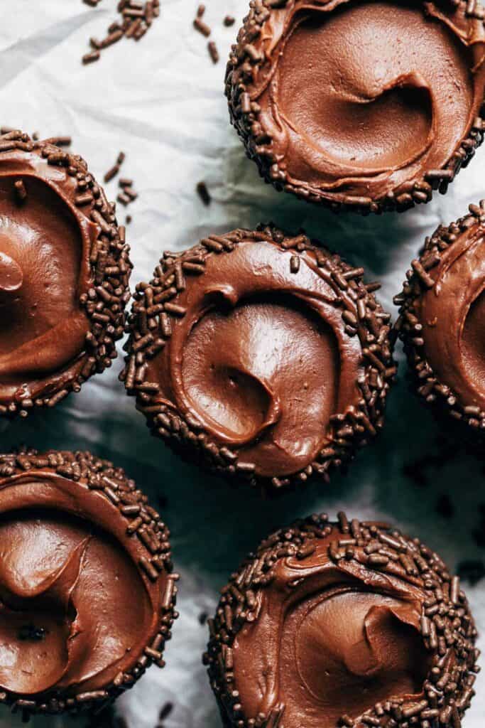 the tops of chocolate cupcakes swirled with chocolate sour cream frosting