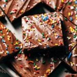 close up a slice of a lunch lady brownie with glossy frosting on top