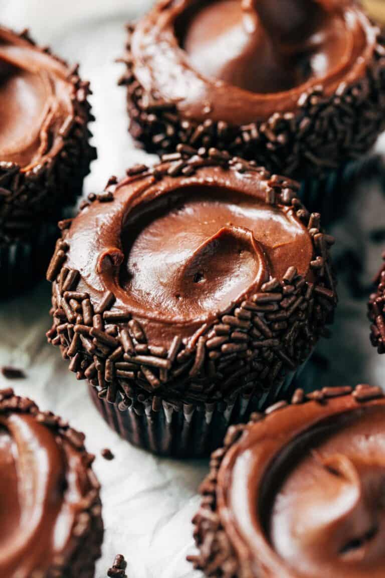 chocolate frosting swirled on top of a chocolate cupcake