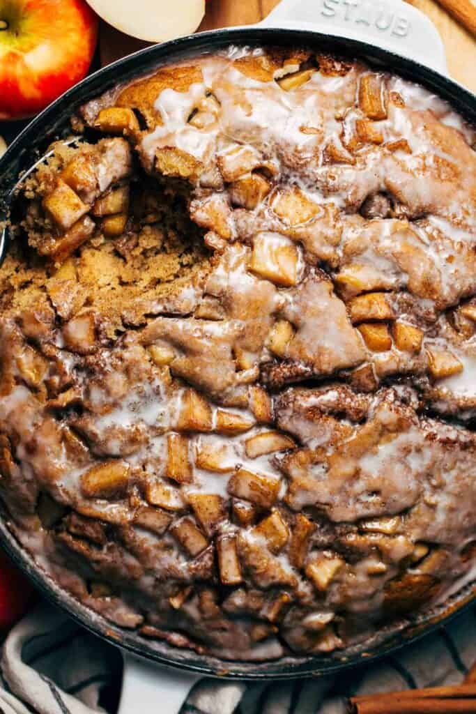close up on an apple fritter cake topped with an icing glaze
