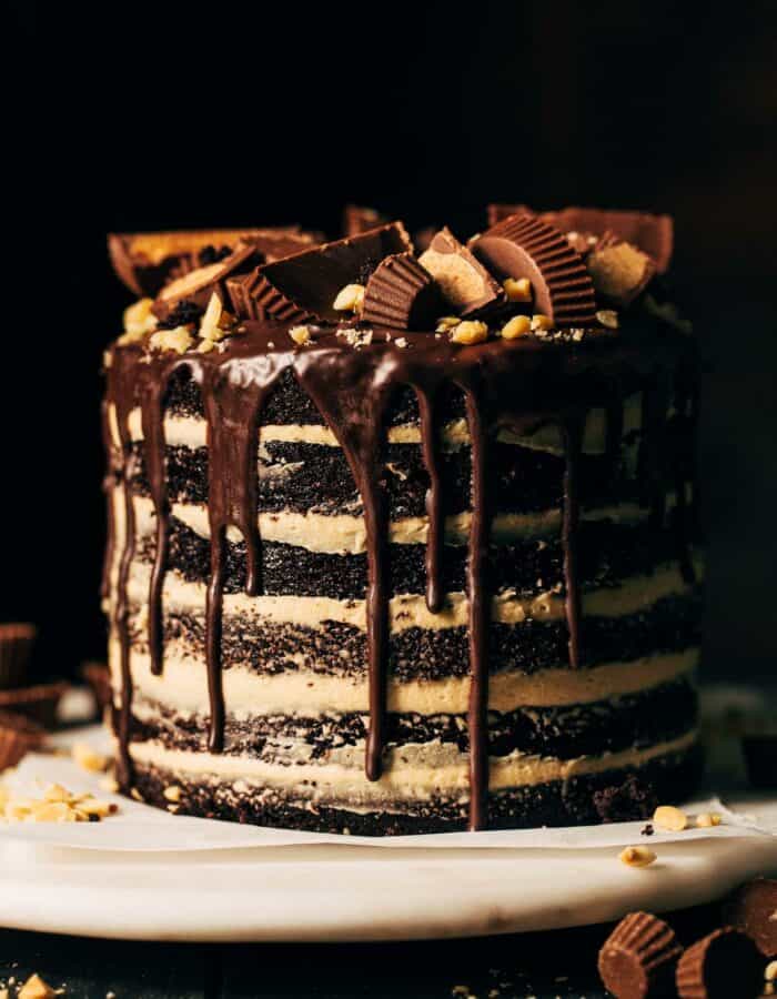 a 6 layer chocolate cake with peanut butter frosting and chocolate cake drip