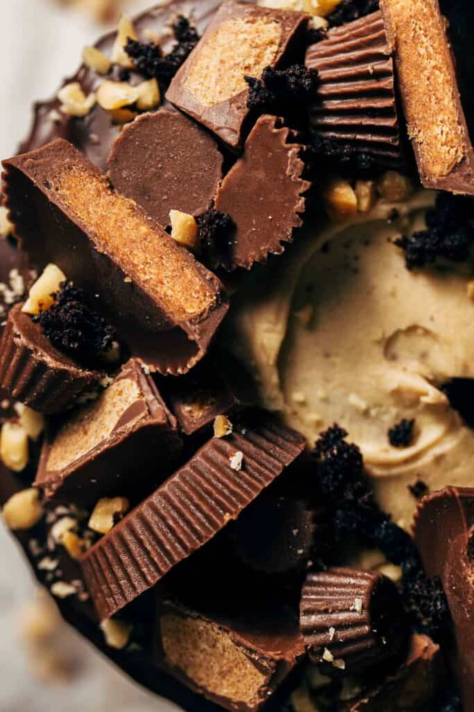 peanut butter cups on top of a chocolate peanut butter cake