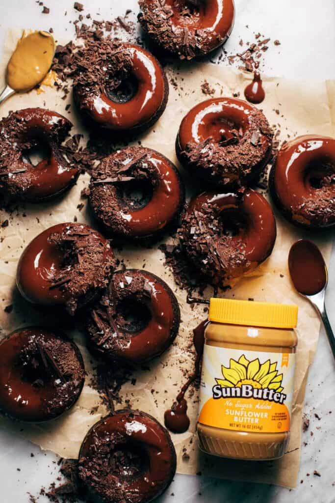 chocolate donuts with a jar of sunbutter