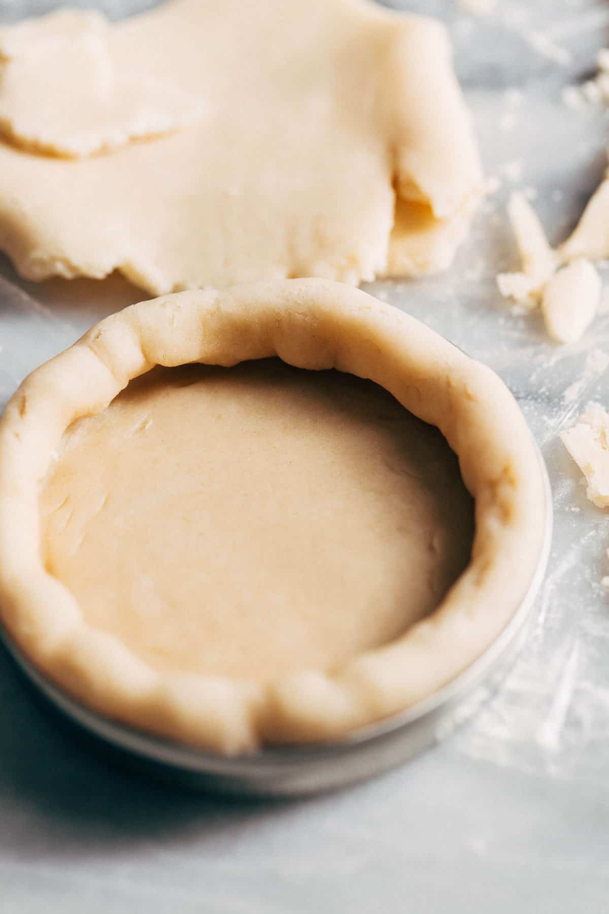 pressing pie dough into a mason jar lid