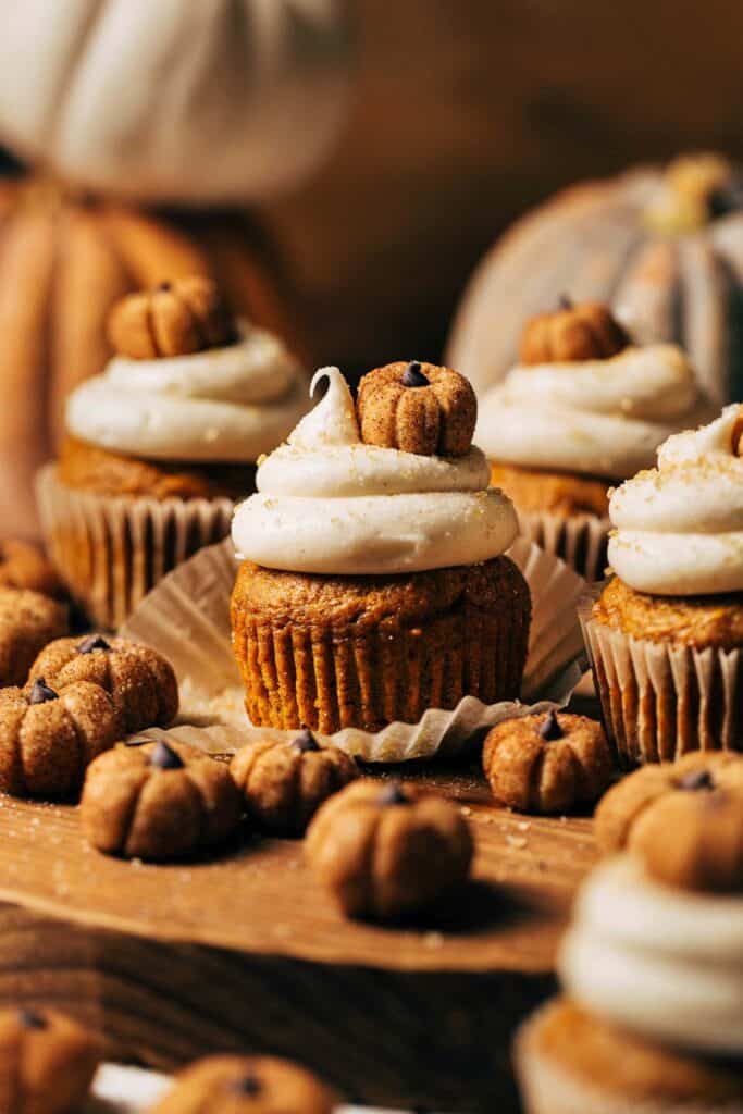 pumpkin cupcakes on a wood serving tray