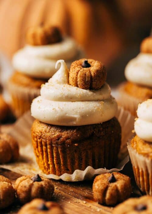 close up on a pumpkin cupcake topped with a tiny pumpkin truffle