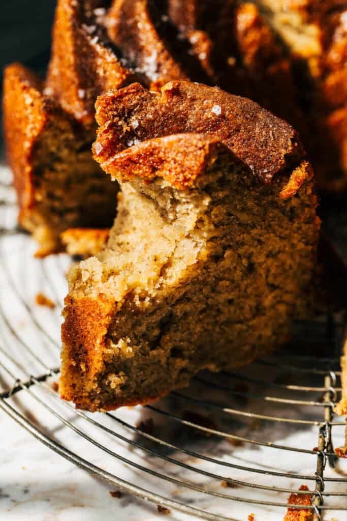 a bite taken from a slice of banana bundt cake