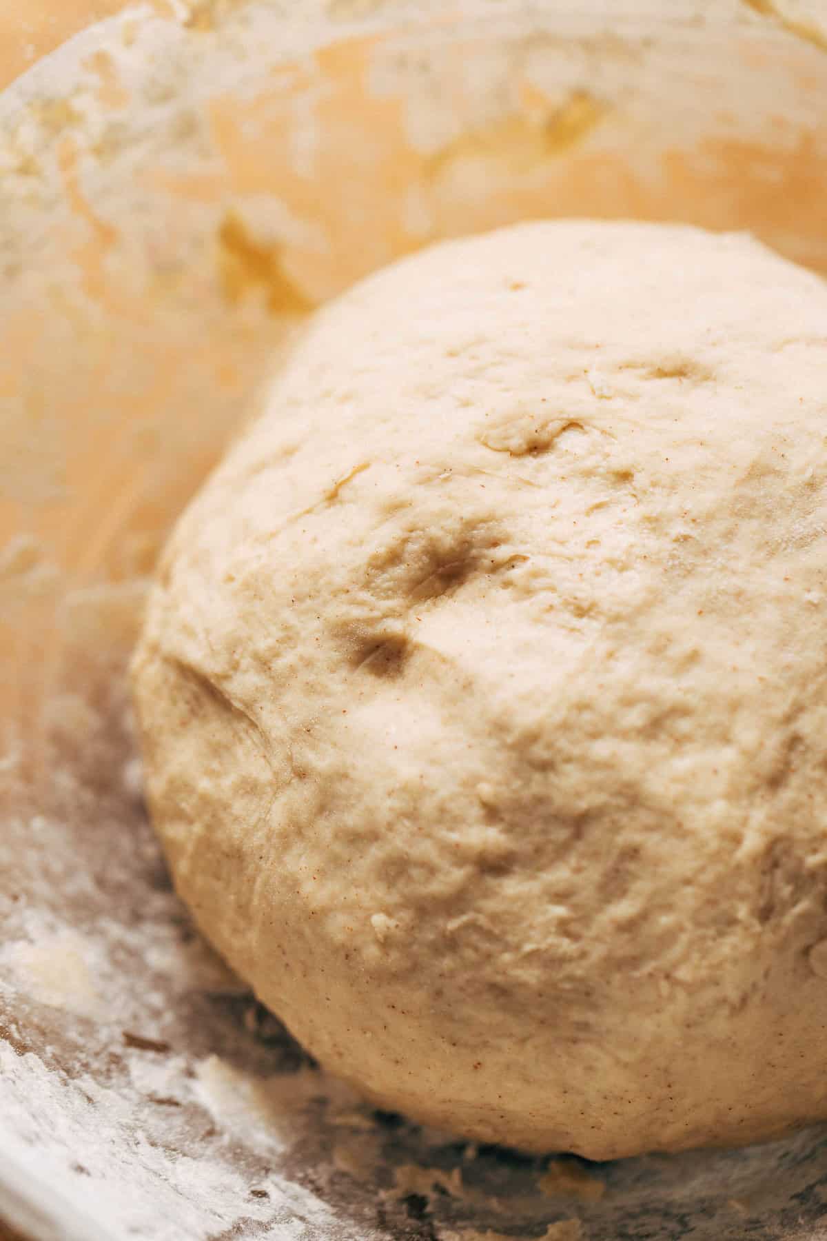 a ball of smooth cinnamon roll dough