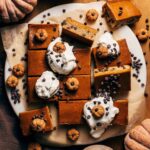 the tops of sliced pumpkin pie bars with a chocolate chip cookie crust