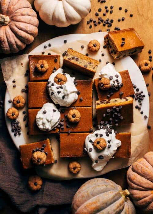 the tops of sliced pumpkin pie bars with a chocolate chip cookie crust