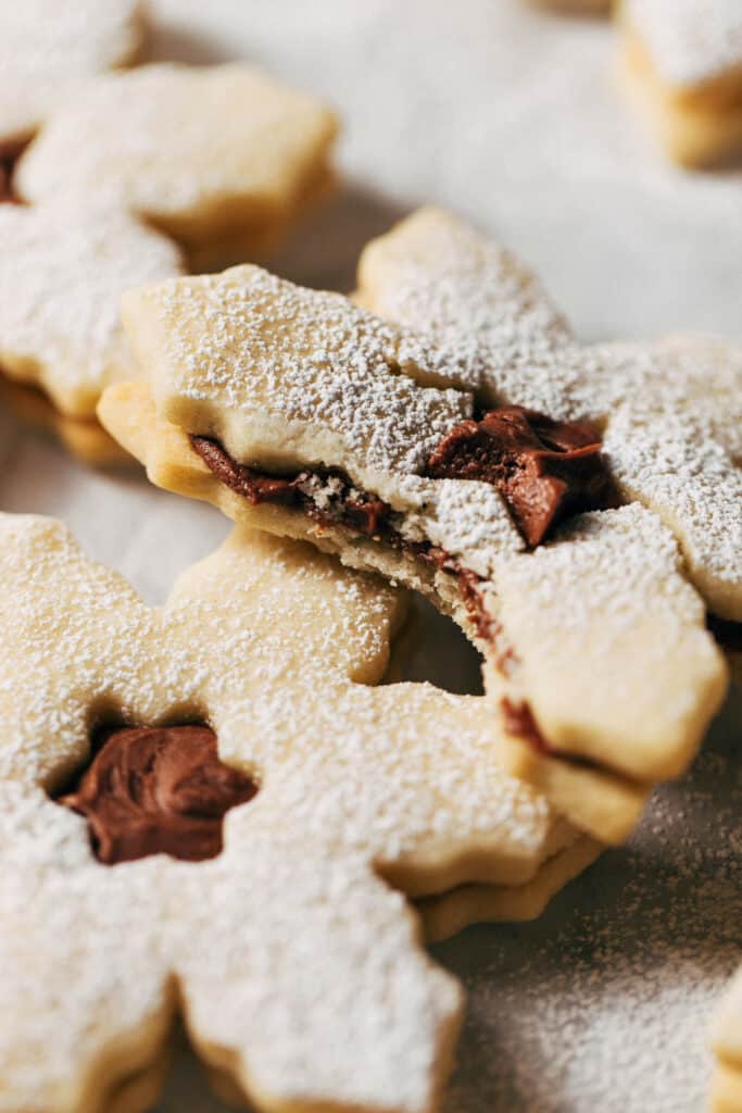 a bite taken from a milk chocolate filled snowflake cookie