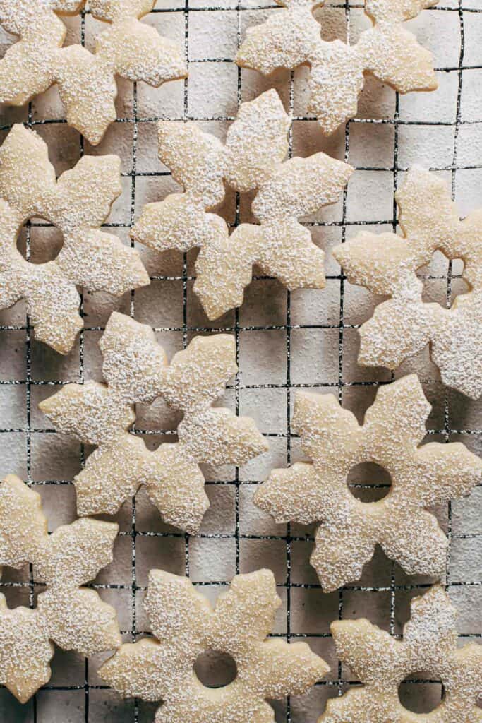 snowflake cookies on a cooling rack
