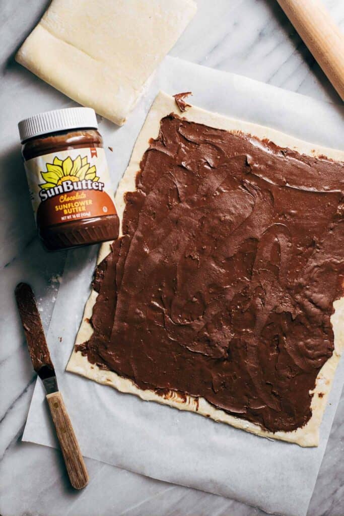 chocolate SunButter spread on a sheet of puff pastry