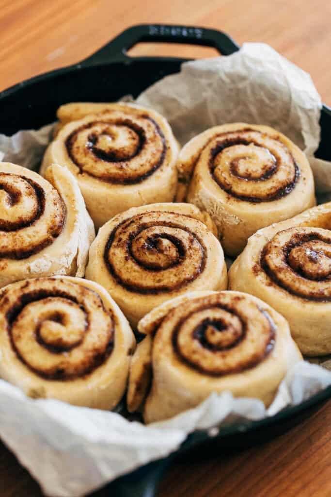 puffed cinnamon rolls in a skillet