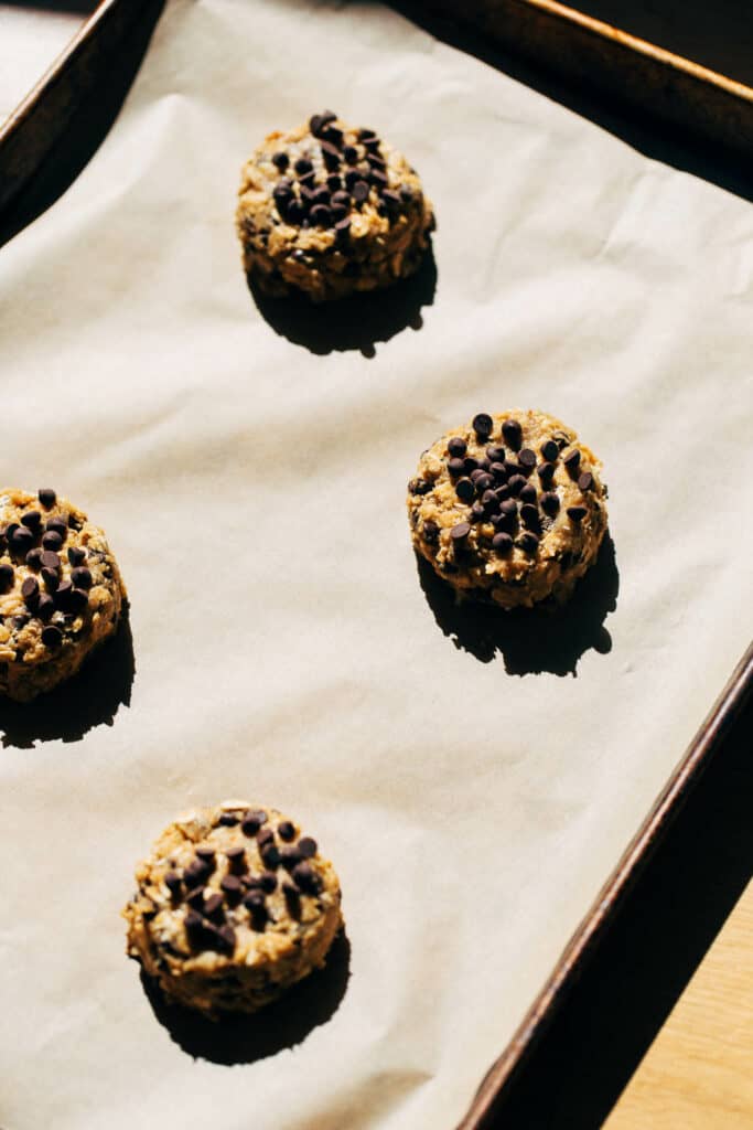 oatmeal chocolate chip cookie dough balls on a baking tray