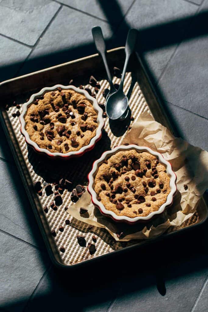 two mini skillet cookies on a baking dish